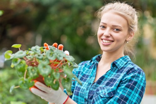 Professional gardener trimming overgrown shrubs