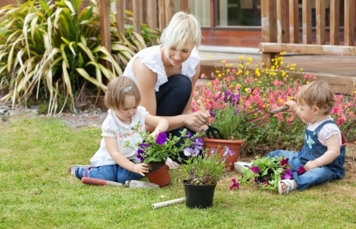 Professional gardener planting flowers in Crossness garden