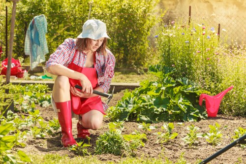 Expert gardener preparing a garden for spring in Hatch End