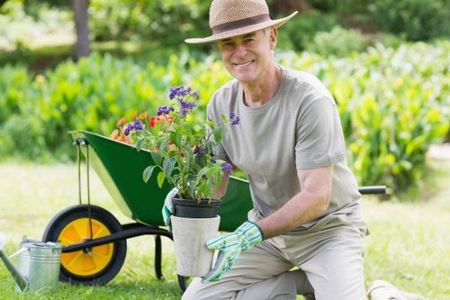 Gardener maintaining a lush garden in Muswell Hill